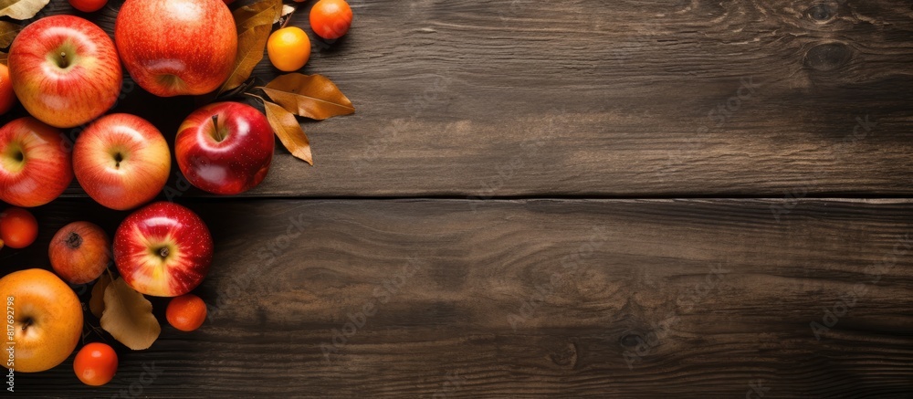 Poster a top view shows a rustic wooden table adorned with ripe red apples and raw orange pumpkins offering