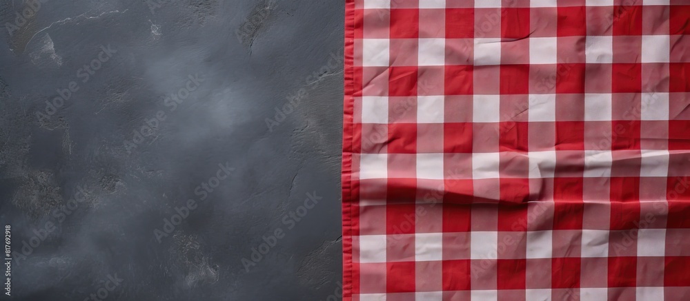 Leinwandbilder a red checkered tablecloth lays on a dark stone surface providing a copy space image from a top view