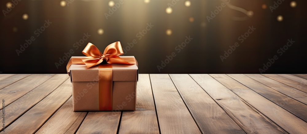 Poster a copy space image featuring a gift box with a bow placed on top of wooden background planks