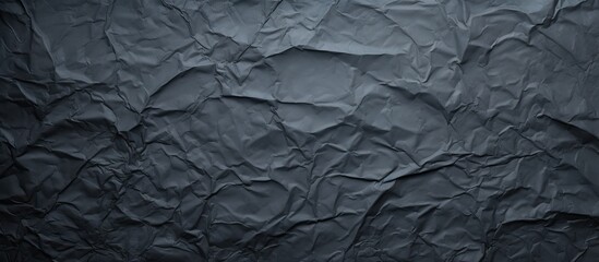 The dark paper with a creased texture serves as the background for the copy space image