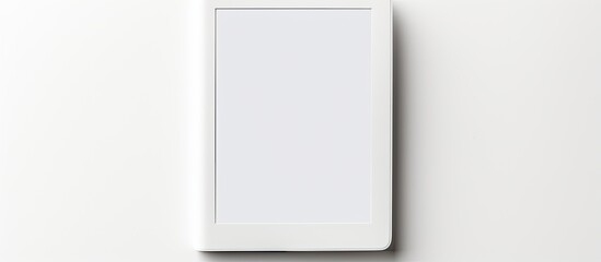 A modern e book reader is placed on a white background creating a flat lay composition with ample room for additional text - Powered by Adobe