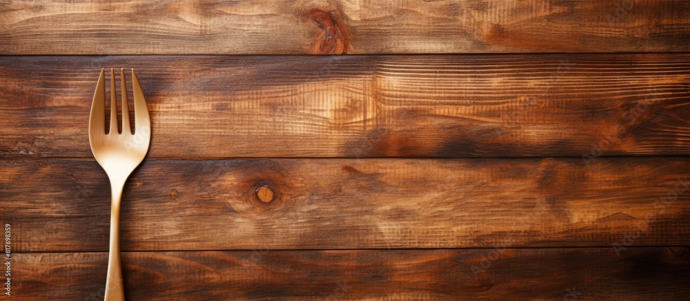 Aufkleber Copy space image of a wooden background adorned with a spoon and fork