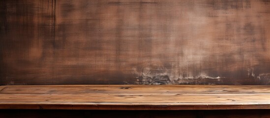 An old grungy wooden desk with a vintage brown texture provides a rustic background for a copy space image