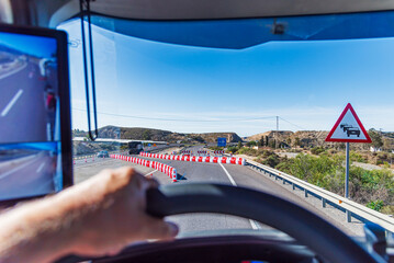Fototapeta premium View from the driver's seat of a truck of a lane change on a highway under construction, transfer.