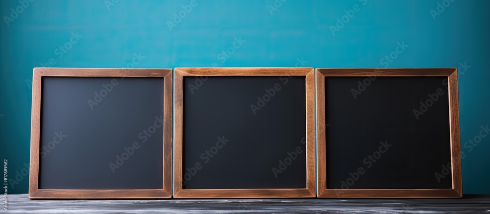 Leinwandbilder a copy space image showing a hand holding a blank mini blackboard against a blue background perfect 