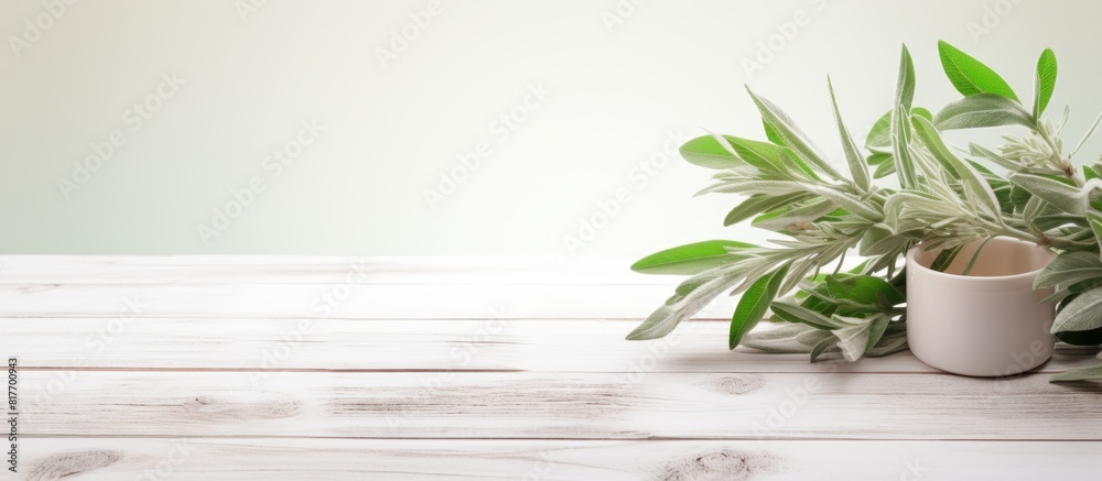 Aufkleber copy space image of a white wooden table adorned with green leaves and a cup of sage tea perfect for