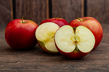 Four Polish red apples on a rustic background