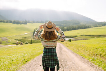 Beautiful young woman enjoy on the slopes of mountain. Travel, nature concept. 