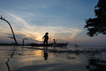 Fisherman of Lake in action when fishing, Thailand