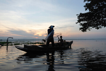 Fisherman of Lake in action when fishing, Thailand