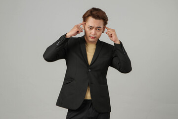 portrait of pensive asian businessman wearing suit with thinking gesture on isolated background