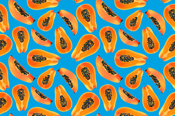 Naklejka premium Papaya fruit slices on a blue background