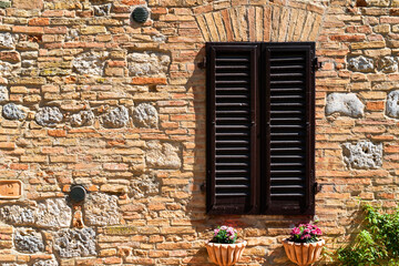 rustic window with shutters and flower pots