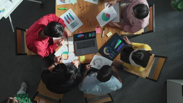 Time lapse of business people analyzing data and sharing idea about financial chart. Top down aerial view of marketing team discussing about investment plan and putting hand together. Convocation.