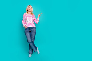 Full length photo of positive retired person wear striped pullover look directing at offer empty space isolated on blue color background