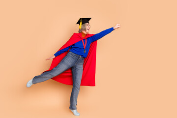 Full size photo of attractive retired woman superman high education dressed stylish blue clothes isolated on beige color background