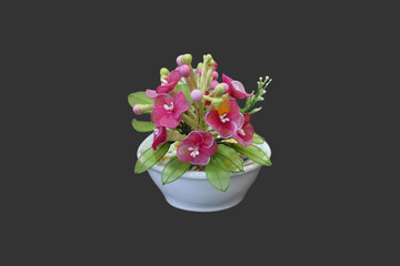 Isolated nylon flower in vase on dark background with clipping paths.