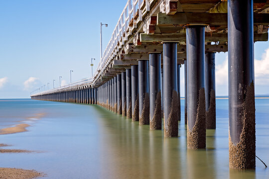 Urangan pier jetty, under underneath below, Hervey Bay, Queensland, Australia, long exposure, sunny day, travel destination tourism tourist, family summer holiday vacation