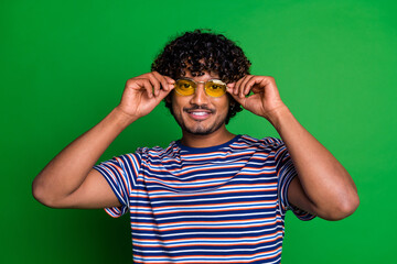 Portrait photo of young mexican cool curly haired funny man wearing sunglass student in striped t...