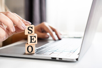 Search Engine Optimization concept with woman hand typing on keyboard laptop , using SEO for search...