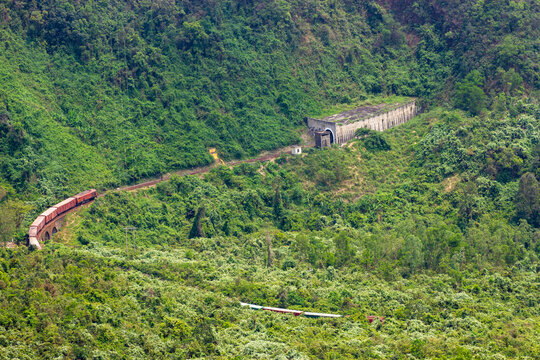A Long Freight Train Entering Tunnel In Hai Van Pass, Vietnam.