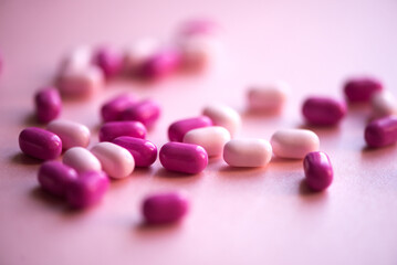 Array of pink pharmaceutical drugs arranged on a table in the shape of a heart