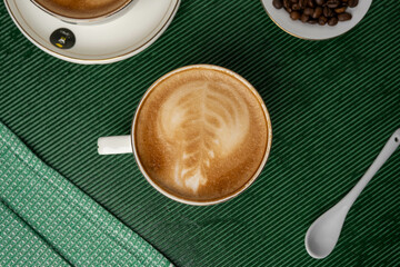 Steaming cup of cappuccino topped with foam