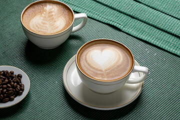 Steaming cup of cappuccino topped with foam