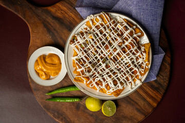 Freshly-baked pizza  sitting on a wooden table