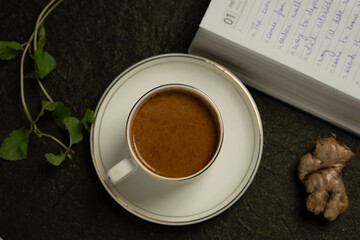 there is a cup of coffee and some kind of book on the table