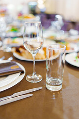 An empty wine glass and a glass on the served dining table. tableware for a banquet. catering services for the holiday.
