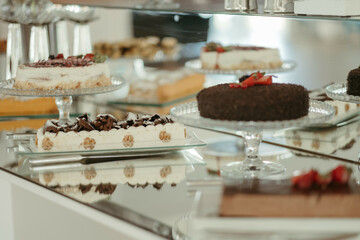 a table with cake and other deserts sitting on it, with clear glass plates