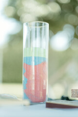 there are many colored sand in a glass with a laptop