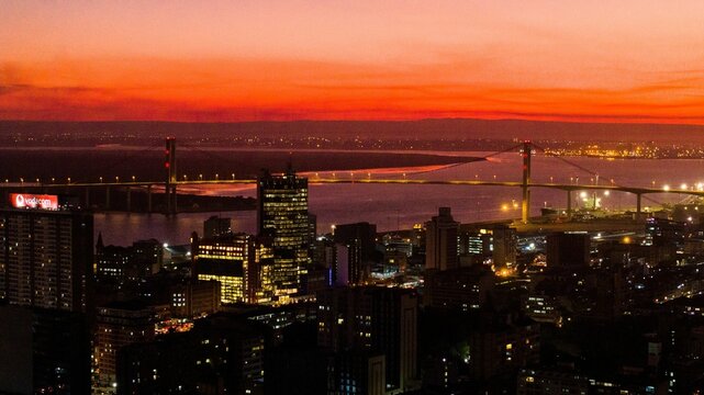 Aerial view of the city of Maputo with buildings and the Maputo bridge at sunset