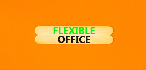 Flexible office symbol. Concept words Flexible office on beautiful wooden stick. Beautiful orange paper background. Business Flexible office concept. Copy space.
