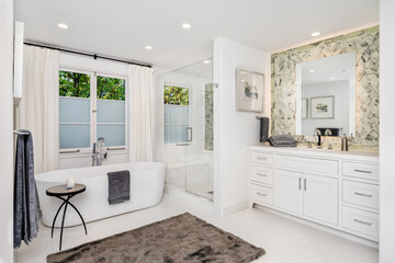 Pristine white bathroom with a large, luxurious bathtub