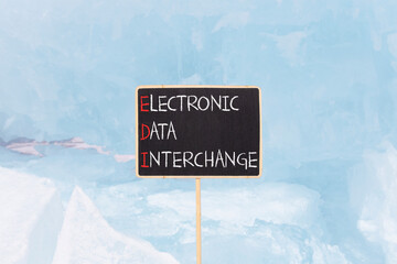 EDI electronic data interchange symbol. Concept words EDI electronic data interchange on blackboard. Beautiful blue ice background. Business and EDI electronic data interchange concept. Copy space.