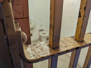 Old metal bars of a door in a prison