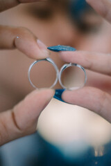 Fototapeta premium Wedding rings held by a loving couple, symbolizing their commitment and unity