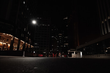 empty empty streets and tall buildings in the city at night