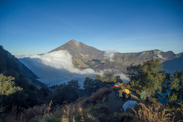 Camping near a majestic mountain with a sea of clouds in the valley