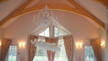 Ascending footage of luxury wedding reception tables and fancy wedding hall