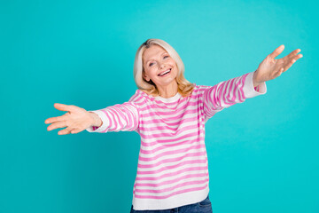 Portrait of positive senior person with wavy hairdo wear striped pullover stretching arms to hug you isolated on blue color background