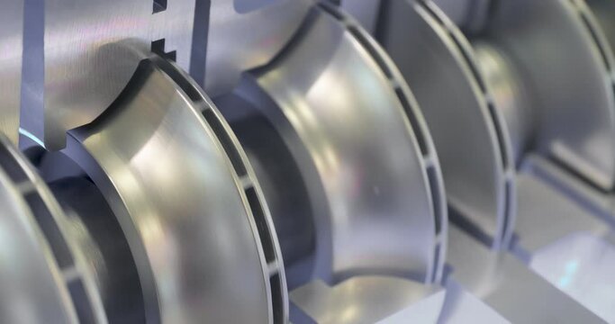 Internal structure of a centrifugal pump. Close-up handheld shot, real time motion, artificial indoors light. Abstract industrial background.