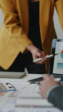 Vertical footage of Close up of hand teamwork business group are meeting working calculate and brainstorming about business financial and marketing on paperwork and presentation.