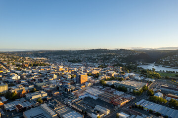 Obraz premium Aerial photo looking out over Launceston above the North Esk River at sunset with blue sky