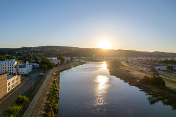 Aerial photo looking out over Launceston above the North Esk River at sunset with blue sky