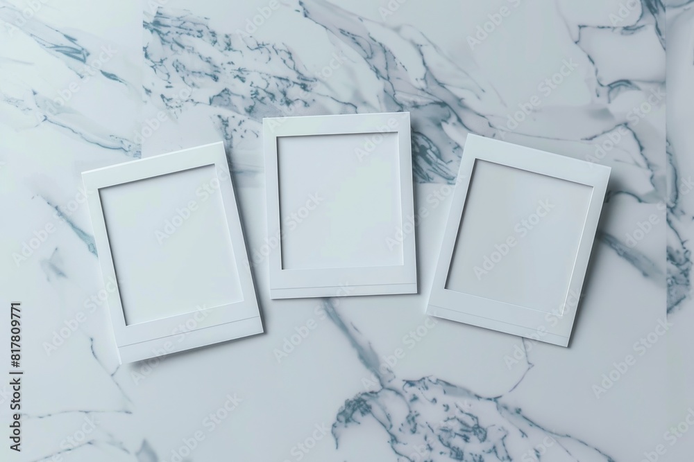Poster Three empty white picture frames on a marble surface. Perfect for interior design concepts