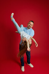 Joyful Lift. father lifts his daughter into air, creating moment of pure joy and exhilaration...
