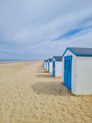 Colorful beach huts line the sandy shores of Texel in the Netherlands, creating a picturesque and...